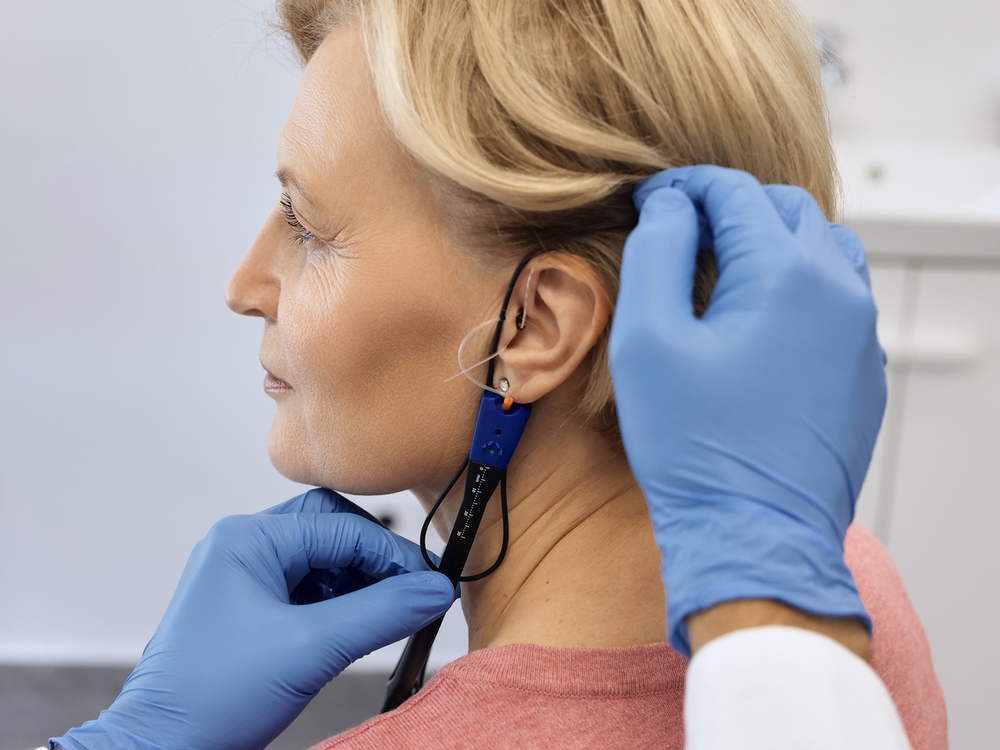 Dr. Beverly Lew, Au.D. performing a real-ear verified hearing aid fitting at Sound Advice in Burbank, CA