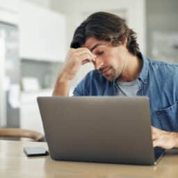Stressed man holding his nose bridge